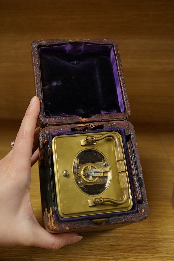 A French brass cased repeating carriage clock, striking on a bell, with key and case, 16cm high. Condition - fair, untested